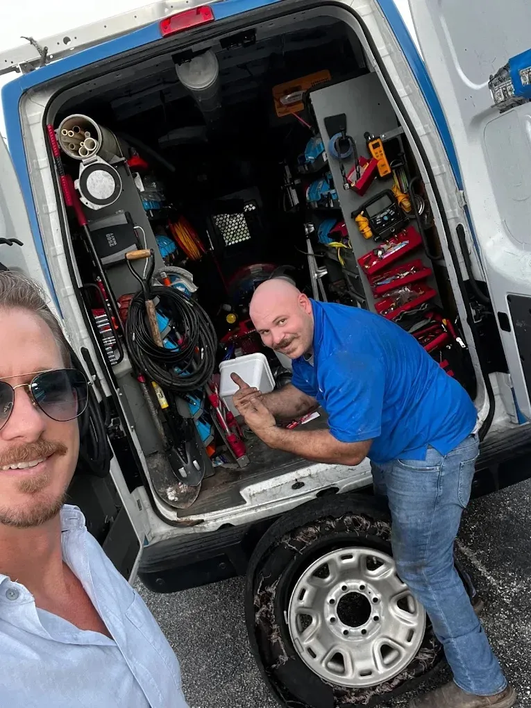 Technician performing maintenance on a residential generator for power reliability