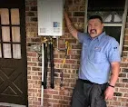 Licensed technician inspecting a water heater for quality emergency repairs